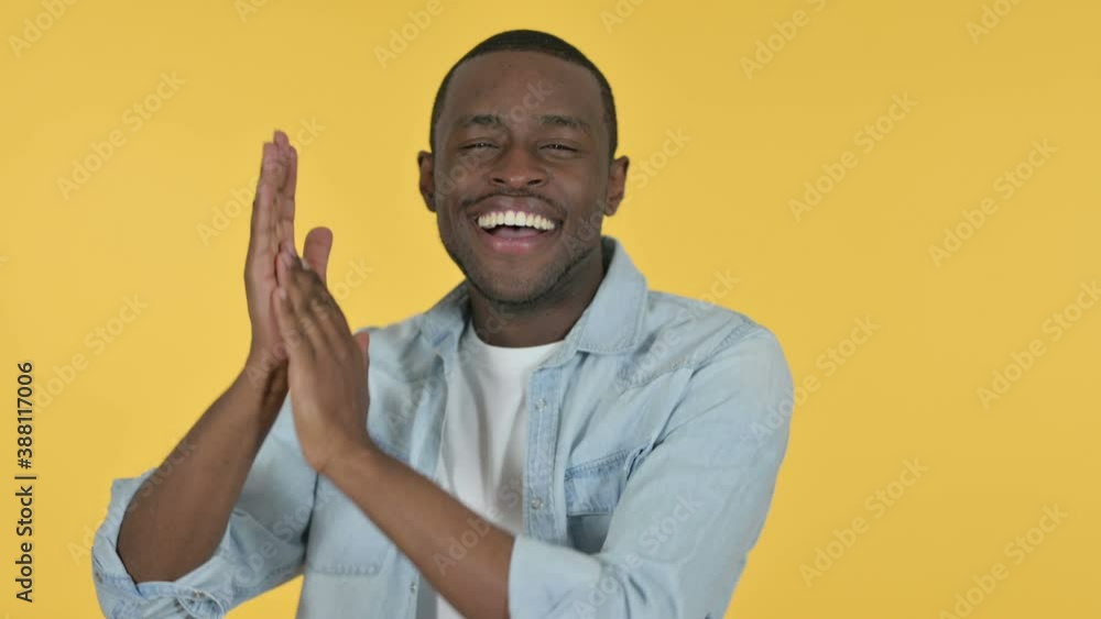 Positive Young African Man Clapping, Yellow Background Positive Young African Man Clapping, Yellow Background