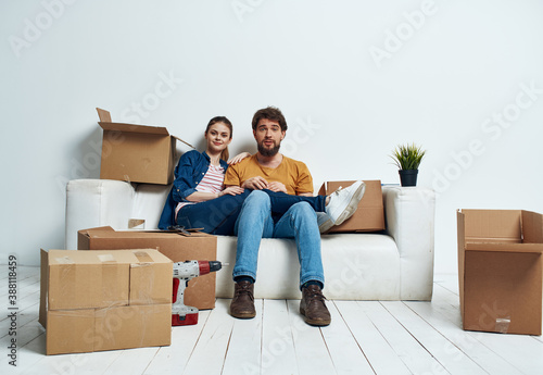Young couple with boxes of things tools room interior © SHOTPRIME STUDIO