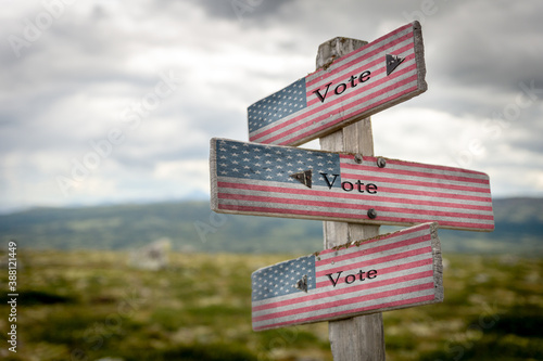 vote vote vote text on signpost with the american national flag.