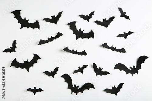 Halloween paper bats on grey background