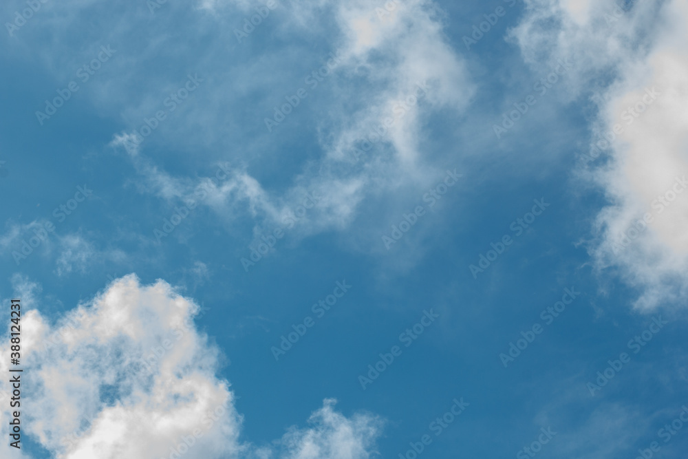 cumulus and high-cumulus clouds of an average tier on blue heavenly space