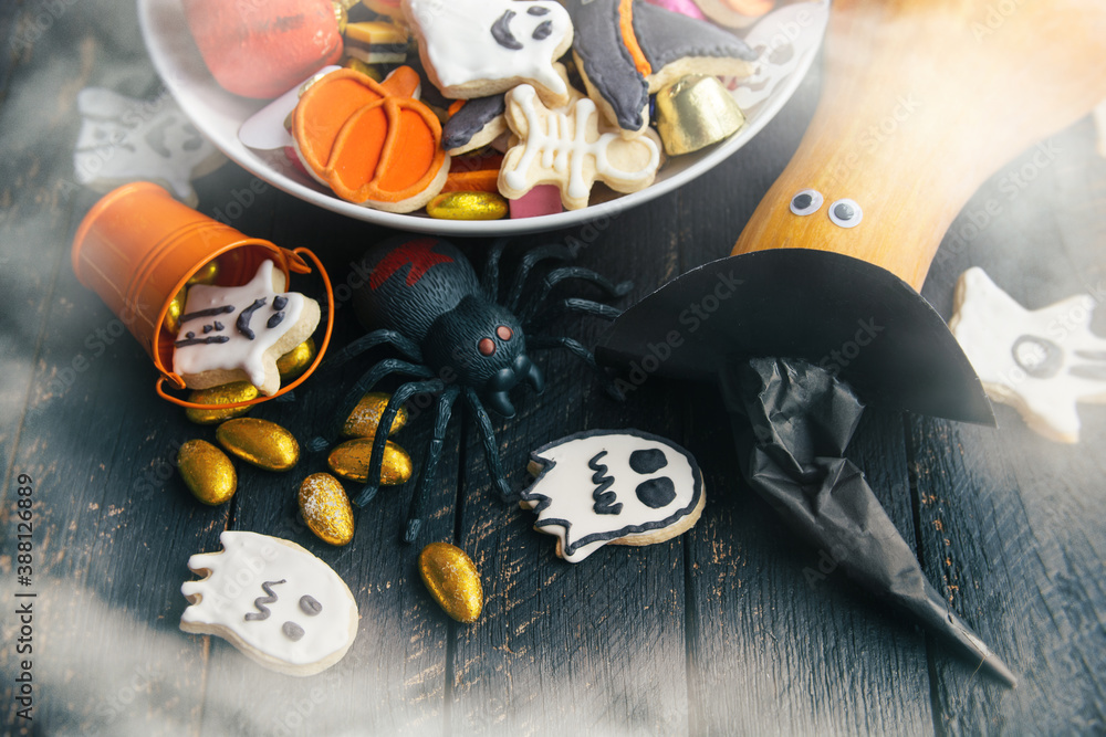 pumpkin in a black witch hat, a bowl of chocolates and sweets, Halloween Jack o Lantern cookies - Trick or Treat Halloween card background
