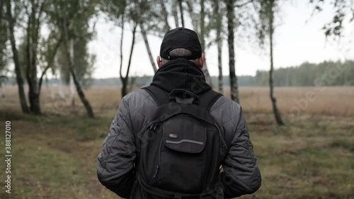 Wallpaper Mural A man with knapsack walks in the amazing autumn forest. Adult  man with backpack in fall forest nature. Torontodigital.ca