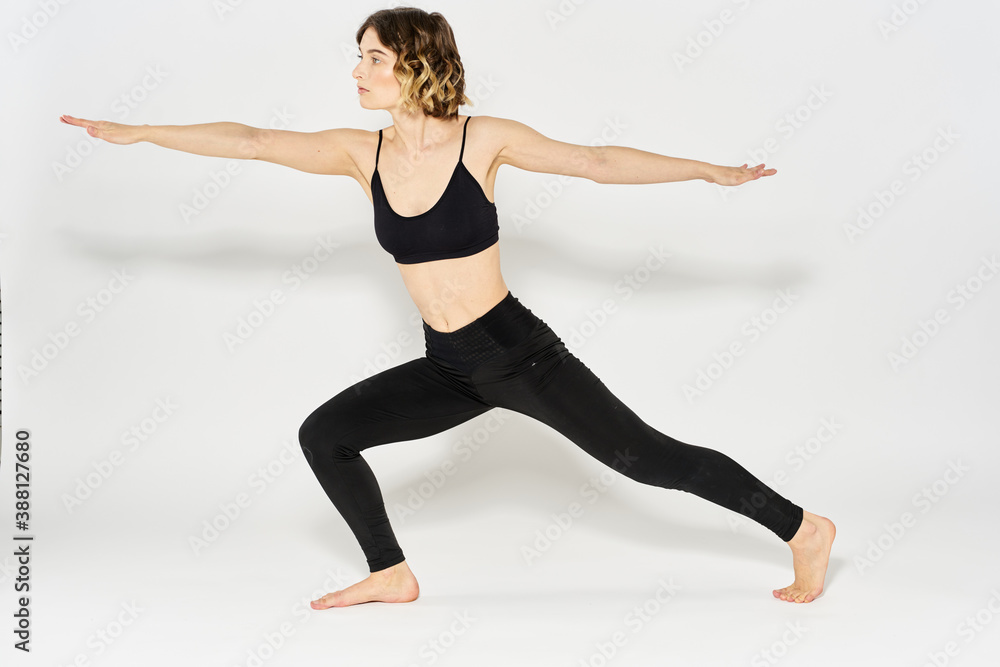 Obraz premium Woman in sportswear is engaged in fitness indoor gymnastics slim figure