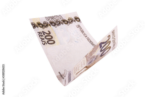 200 reais note falling, with selective focus. Two hundred reais from brazil isolated white background, money from brazil