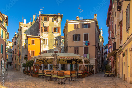 Morning walk in empty Croatian city of Rovinj.Picturesque narrow cobblestone streets,colorful facades,small shops,beautiful European cityscape.Summer holiday background.Real estate concept.
