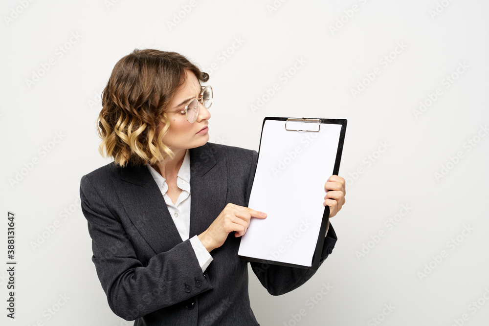Business woman with a folder of documents on a light background cropped view and shirt suit Business woman with a folder of documents on a light background cropped view and shirt suit