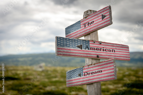 the american dream text on signpost with the american flag painted on