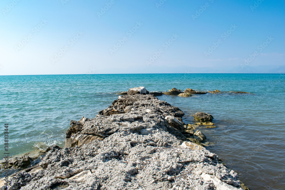 A breakwater in Astrakeri, Corfu, Greece with a view of the Ionian Sea