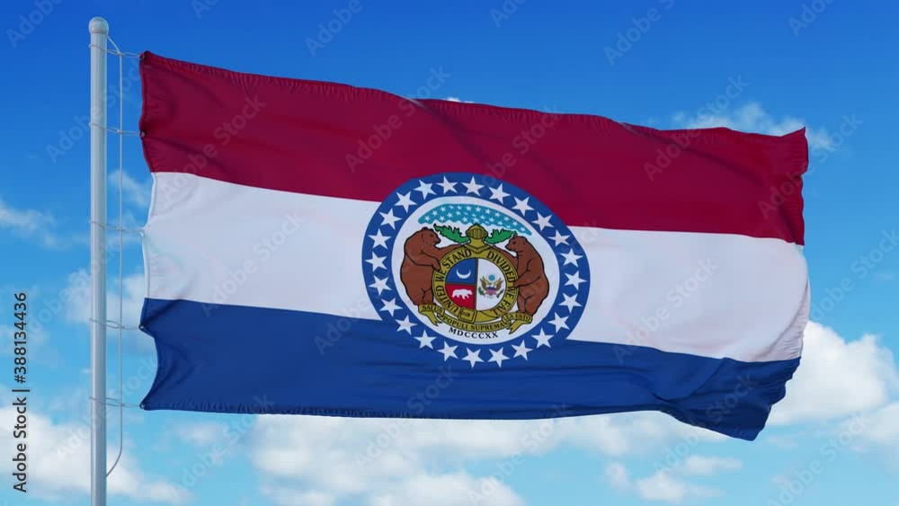 Missouri flag on a flagpole waving in the wind, blue sky background. 4K Missouri flag on a flagpole waving in the wind, blue sky background. 4K