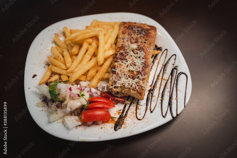 roast meat with cheese and salad on a plate and salad on a plate roast meat with cheese and salad on a plate and salad on a plate
