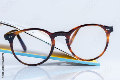Reading glasses on the edge of an open book