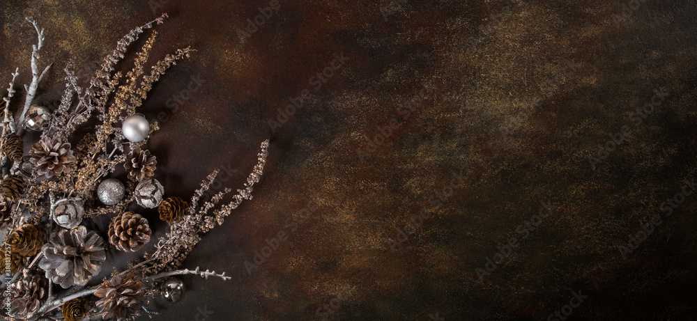 Naklejka premium Christmas background, the composition of their cones and dried flowers on a dark brown background. Abstract composition, idea, decor.