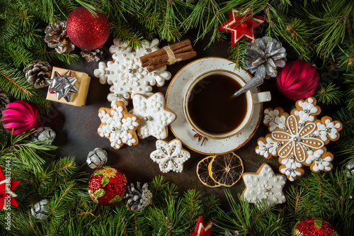 Cup of coffee with gingerbread and fir branches with cones, Christmas balls. New Year's holiday concept. © Arina B