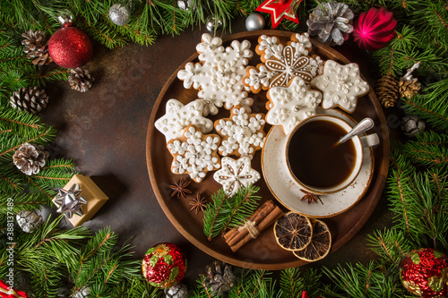 Cup of coffee with gingerbread and fir branches with cones, Christmas balls. New Year's holiday concept.