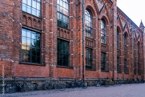 Bikes parked in front of the brick wall of the Copenhagen University Library (designed by Johan Daniel Herholdt) next to the main building of the University in Frue Plads photo