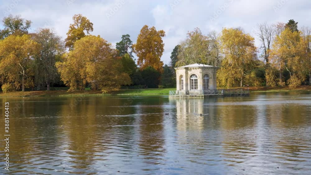Camera Pan over the Pavilion in the middle of the Carp Pond with the royal castle of Fontainebleau in the background. Shot in autumn on a cloudy day - Fontainebleau, France Camera Pan over the Pavilion in the middle of the Carp Pond with the royal castle of Fontainebleau in the background. Shot in autumn on a cloudy day - Fontainebleau, France