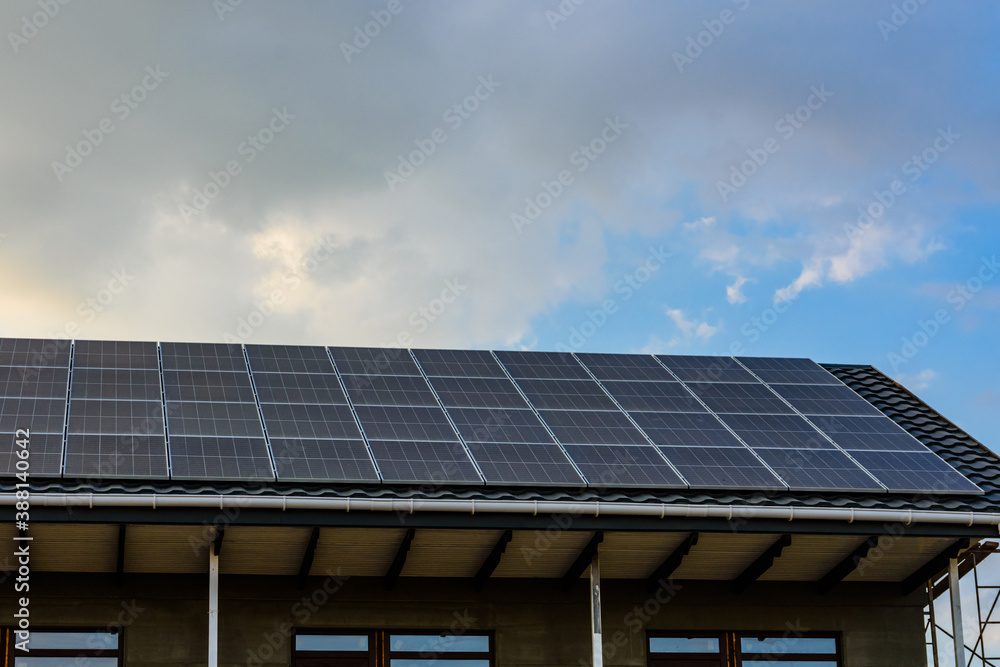 Solar panels on roof of residential house. Clean energy. Ecological concept Solar panels on roof of residential house. Clean energy. Ecological concept
