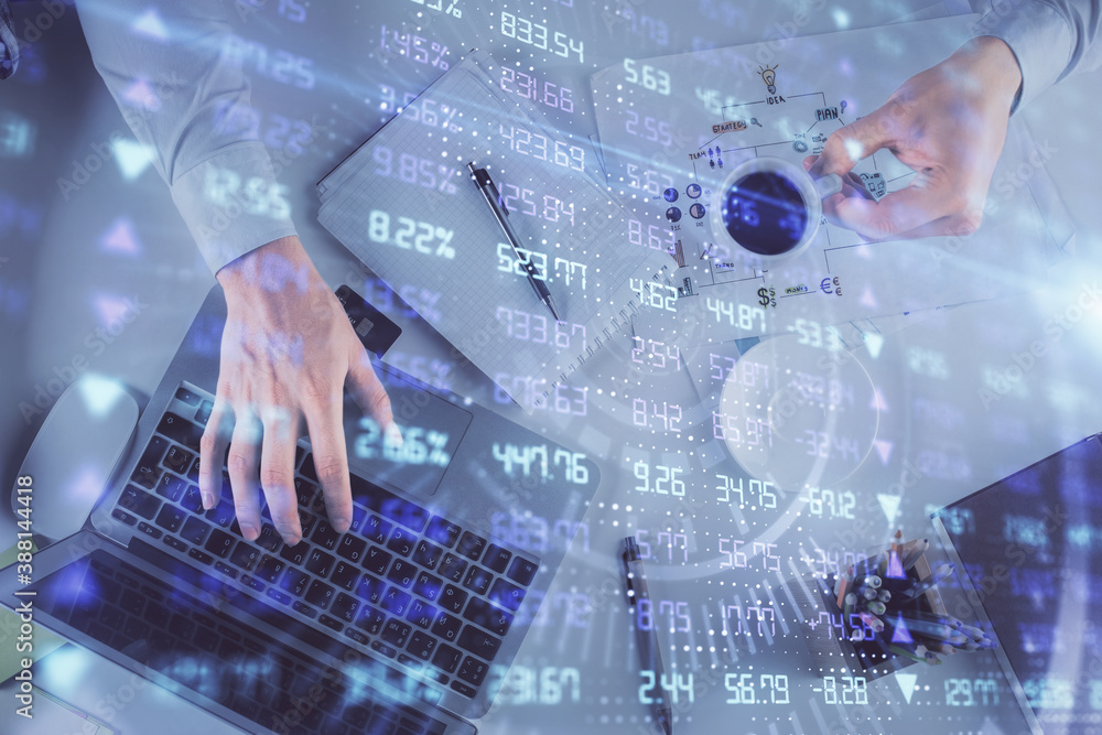 Multi exposure of man's hands typing over computer keyboard and forex graph hologram drawing. Top view. Financial markets concept. Multi exposure of man's hands typing over computer keyboard and forex graph hologram drawing. Top view. Financial markets concept.