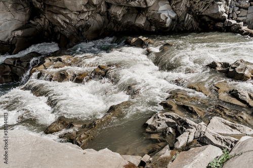 Waterfall in the mountain river with big rocks. Travelling in quarantine period. Nature landscape. Karpathians mountains photo