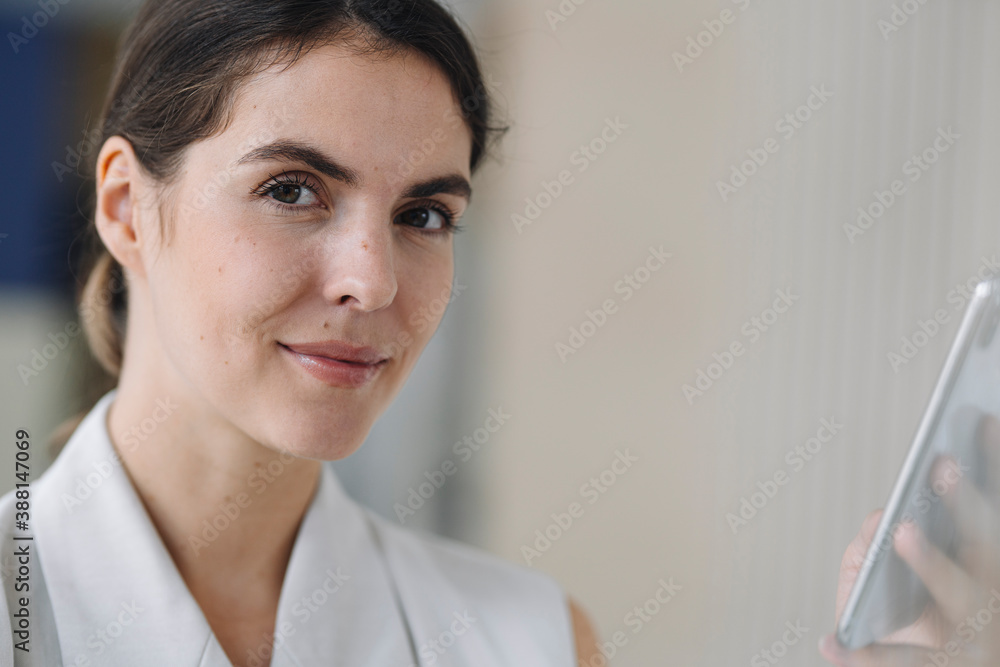 Beautiful woman using mobile phone in office Beautiful woman using mobile phone in office