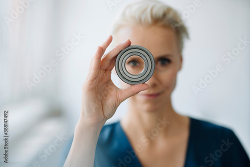 Close-up of businesswoman looking through object in office photo