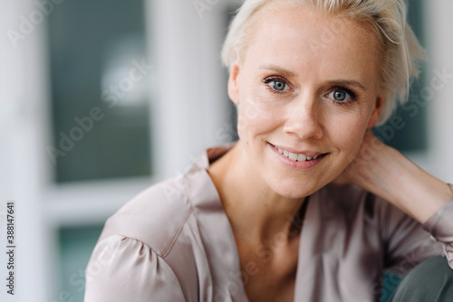 Close-up portrait of smiling businesswoman in office