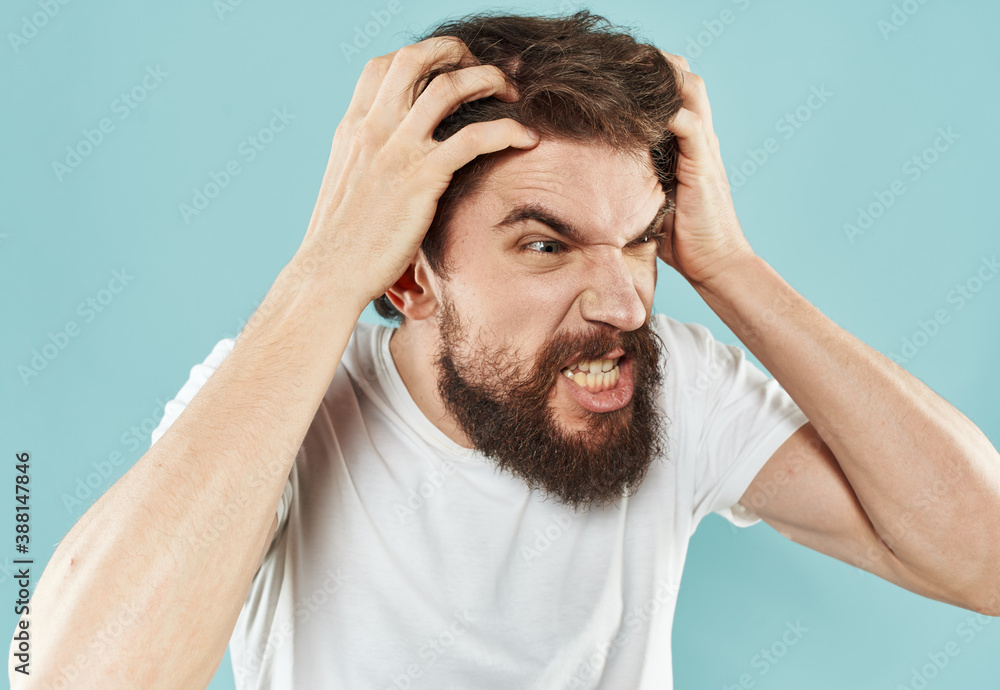 Emotional bearded man on a blue background cropped view of gesticulating with his hands Emotional bearded man on a blue background cropped view of gesticulating with his hands