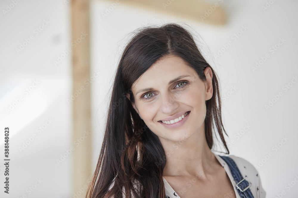 Smiling woman standing in new house Smiling woman standing in new house