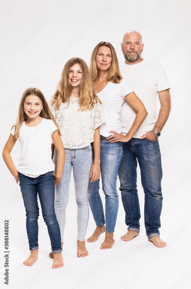Parents with daughters standing against white background Parents with daughters standing against white background