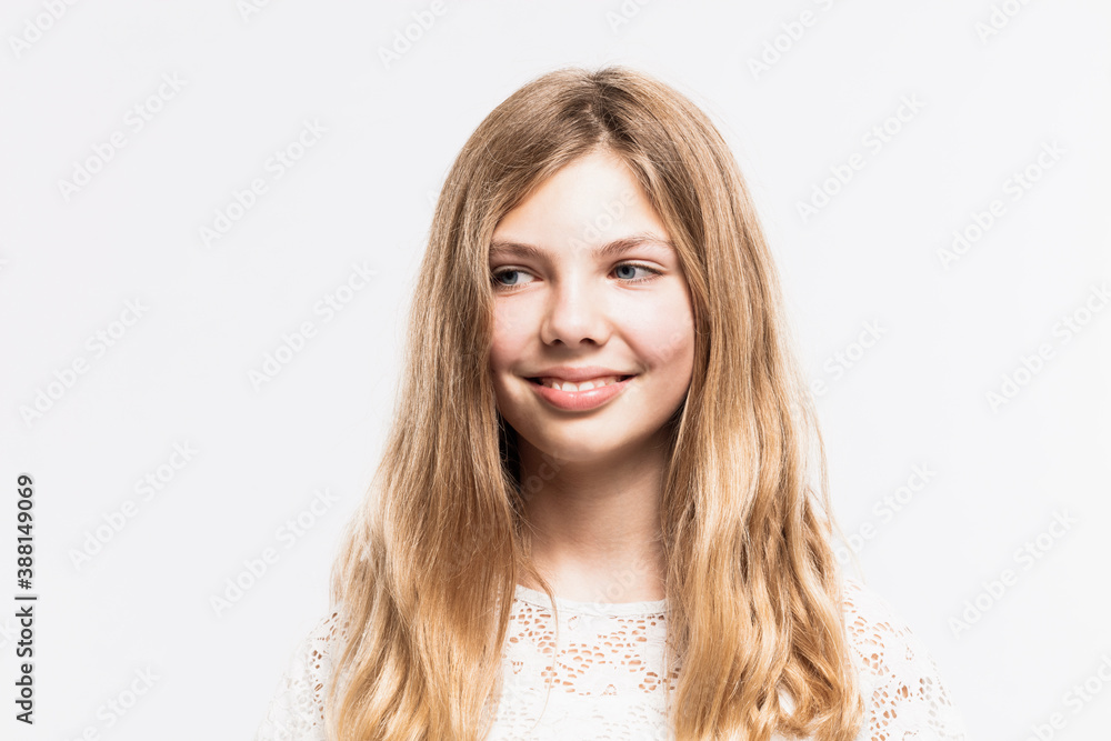 Close-up of smiling girl with blond hair looking away against white background Close-up of smiling girl with blond hair looking away against white background