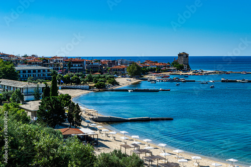 Greece, Chalkidiki, Ouranoupoli, Beach of coastal village in summer photo