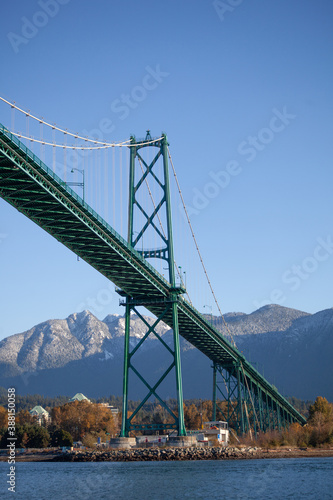 A view of the Lion's Gate Bridge and the North Shore mountains in the background taken from a boat on the water. Looking at North and West Vancouver, British-Columbia
