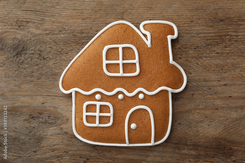 House shaped Christmas cookie on wooden table, top view