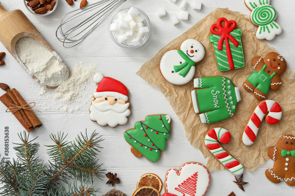 Flat lay composition with delicious homemade Christmas cookies on white wooden table