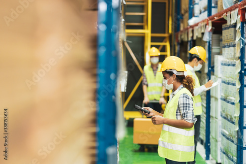Multi ethnic worker wear face mask as new normal work in warehouse