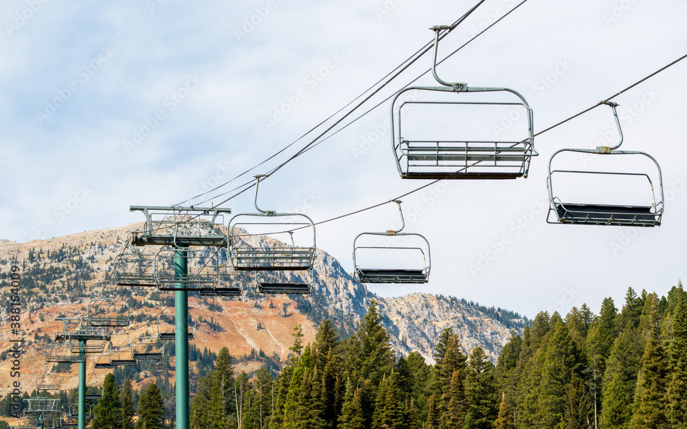 a large empty ski lift  at a closed resort in the Rocky Mountains of Montana with colorful autumn foliage