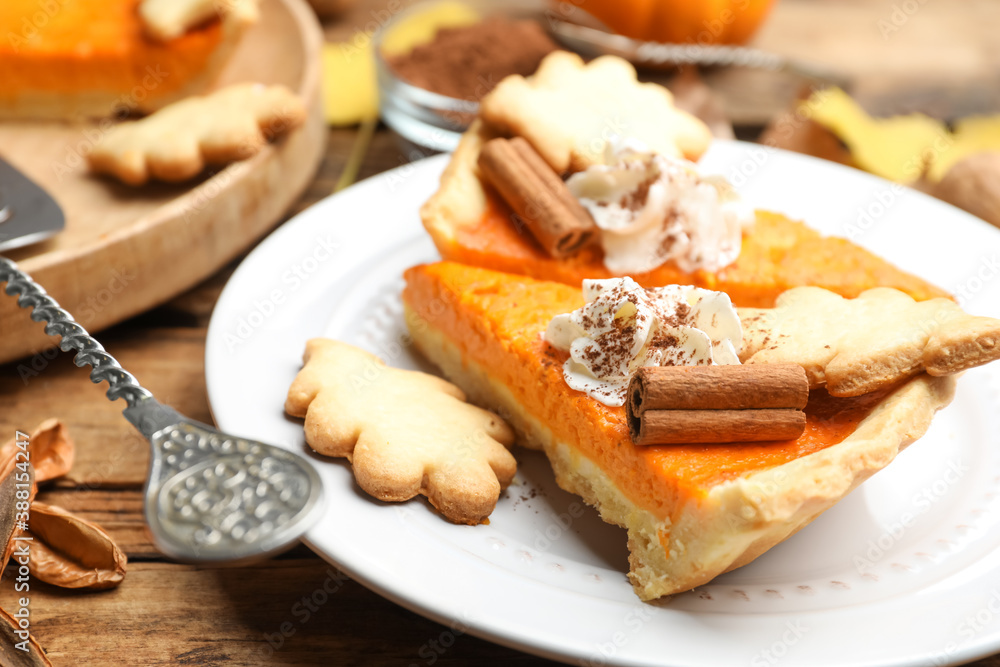 Slices of delicious homemade pumpkin pie on wooden table, closeup Slices of delicious homemade pumpkin pie on wooden table, closeup