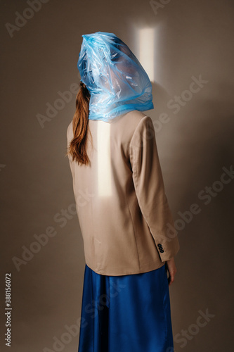 Anonymous woman with blue bag on head