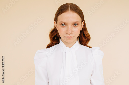 Ginger woman in white retro blouse