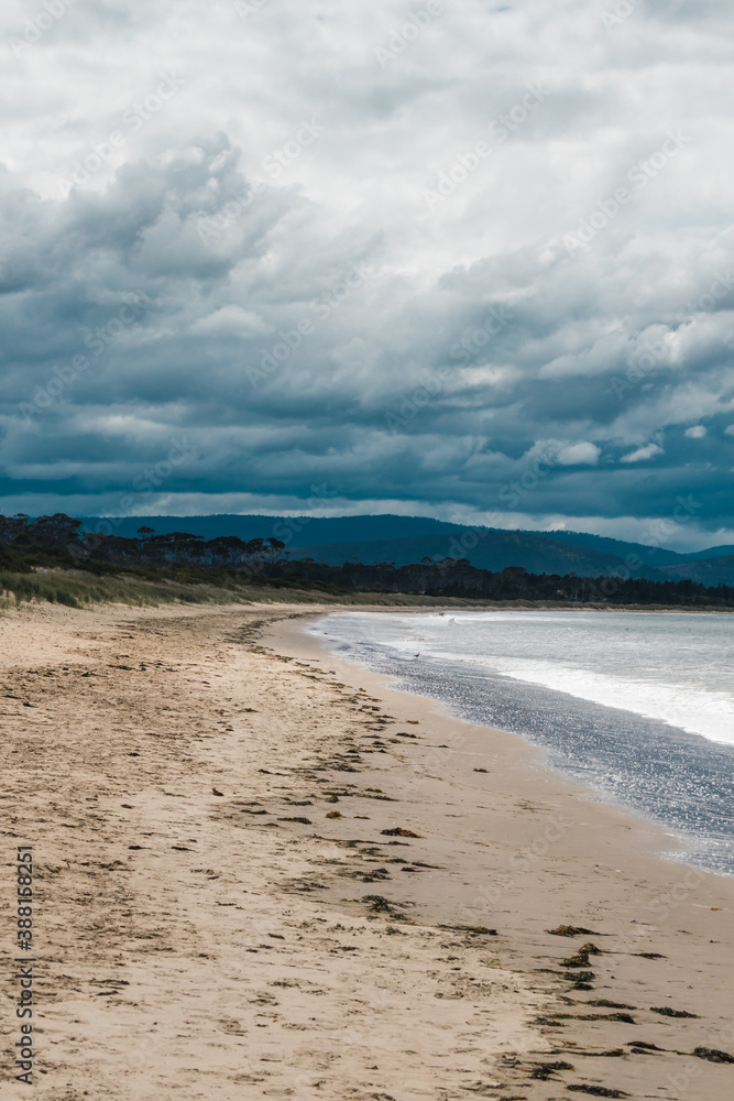 beautiful view of Seven Mile Beach just outside the city of Hobart in Tasmania, Australia on an overcast day with stormy clouds beautiful view of Seven Mile Beach just outside the city of Hobart in Tasmania, Australia on an overcast day with stormy clouds