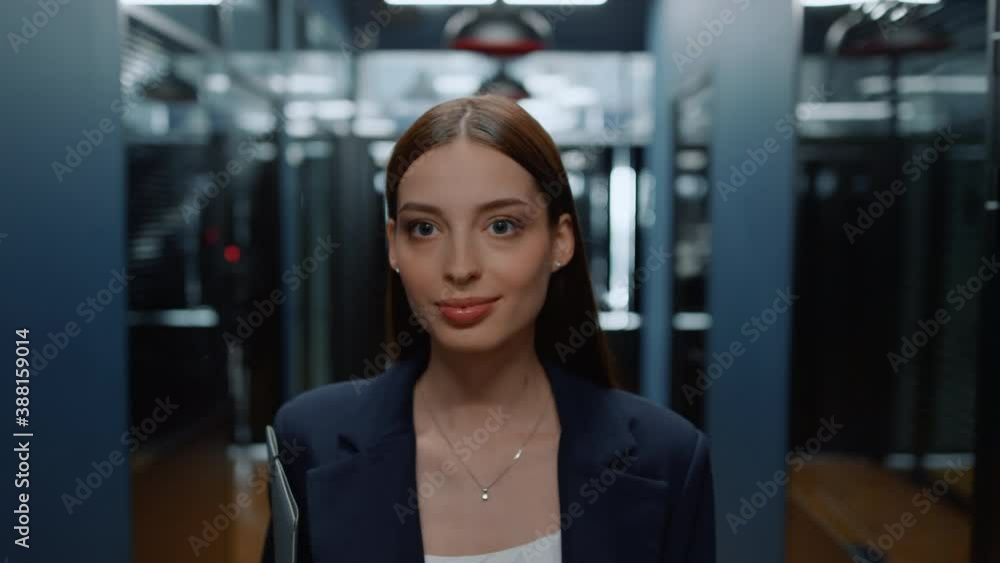 Cheerful lady going on meetup in business center. Woman looking around in office Cheerful lady going on meetup in business center. Woman looking around in office