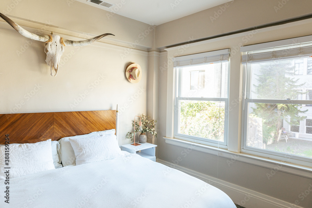 cozy interior of bedroom with white linen sheet, side table and decor cozy interior of bedroom with white linen sheet, side table and decor