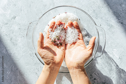 Hand sifting through salt preserved cherry blossoms photo