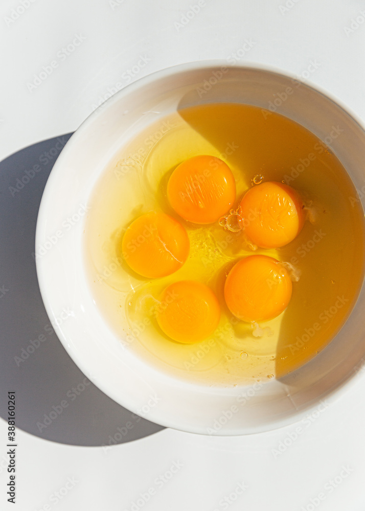 Fresh egg whites and yolks in bowl Fresh egg whites and yolks in bowl