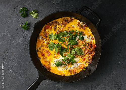 Indian masala omlette in cast iron pan photo