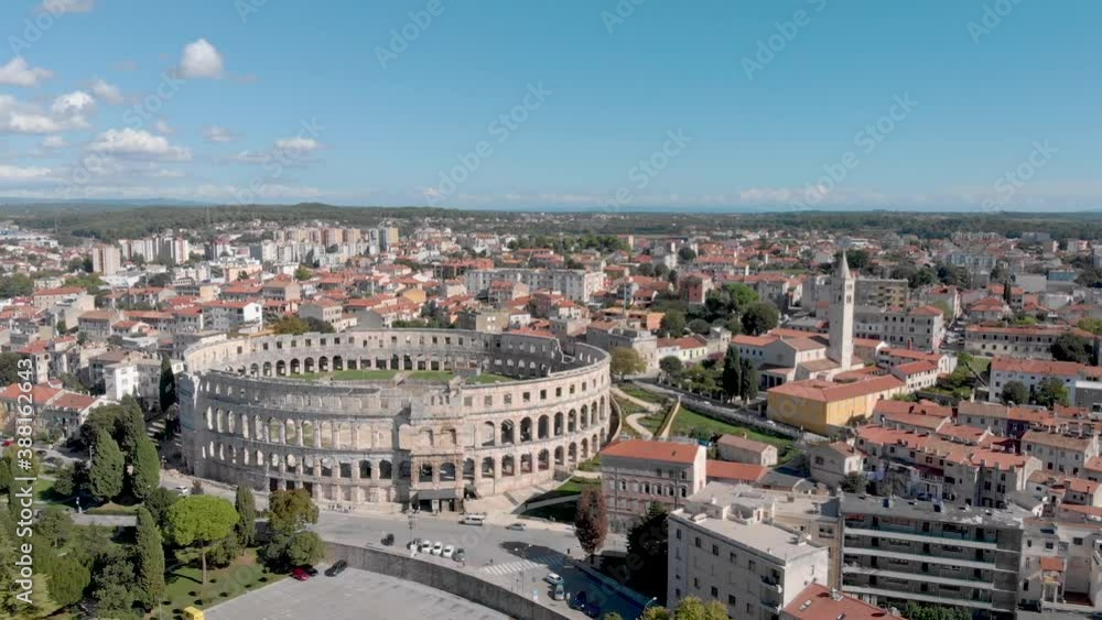 Croatia Tourism - Ancient Ruins of Pula Arena Colosseum. Aerial Establishing View with Copy space in Sky Croatia Tourism - Ancient Ruins of Pula Arena Colosseum. Aerial Establishing View with Copy space in Sky