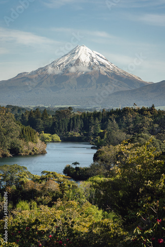 Beautiful landscape of Mount Taranaki over a forest and lake. Vertical photography