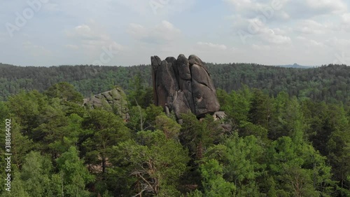 Rocks in the forest. Mountains in the taiga. Krasnoyarsk Pillars National Reserve Park. A very long shot. Aerial view of a drone flying