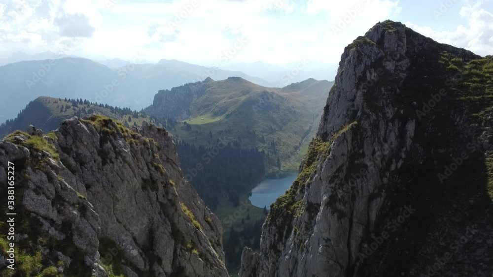 Flying with the drone inbetween two rocks to a beautiful swiss mountain lake (Oberstockensee) Flying with the drone inbetween two rocks to a beautiful swiss mountain lake (Oberstockensee)